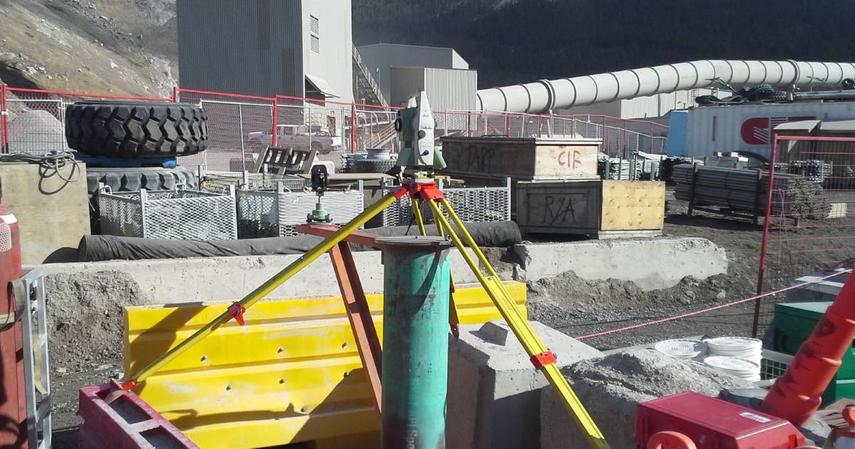 High-accuracy construction surveying with total station and prism on a Calgary commercial build site